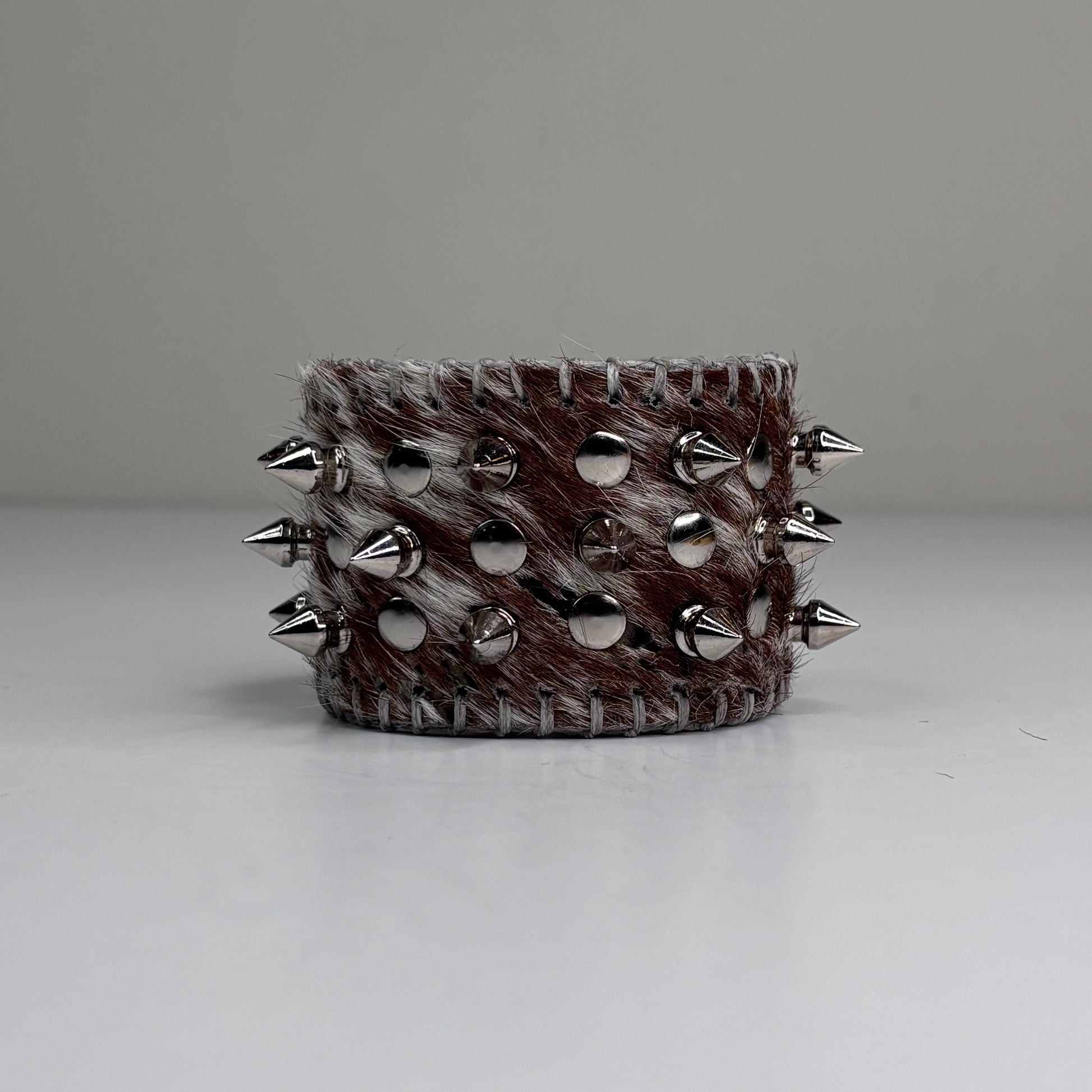 SNAKE PRINT HAIR-ON HIDE MULTI SPIKEY CUFF