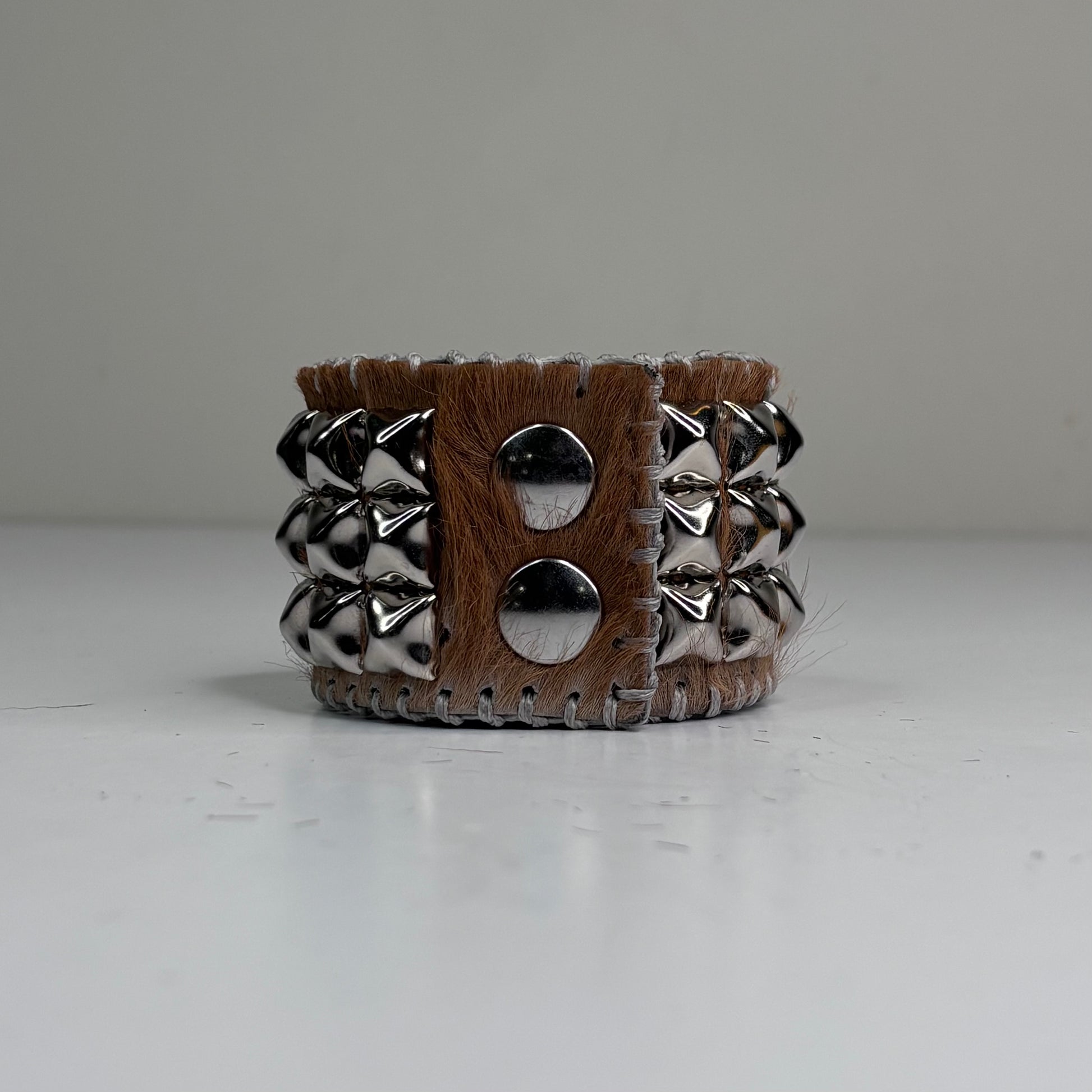 PONY HAIR-ON HIDE WITH CHROME PYRAMID STUDS